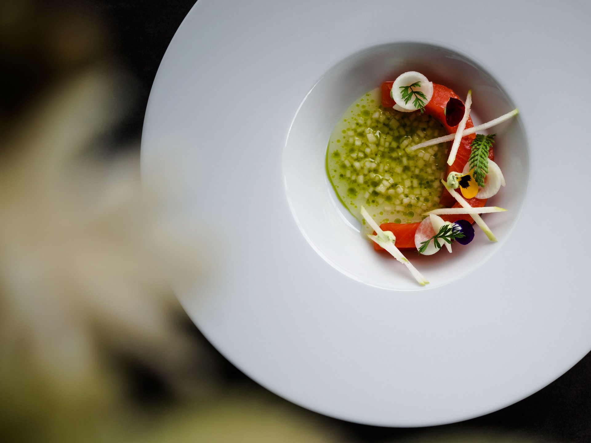 Dorf Tirol: accommodation with style and good food Delicately plated salmon with vegetables and herbs in white dish